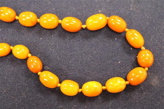 A single strand graduated oval amber bead necklace, gross weight 53 grams, approx. 62cm.